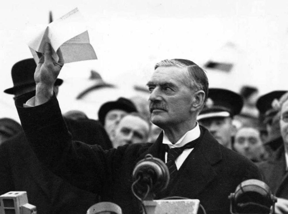 Neville Chamberlain celebrating his success in the Munich Agreement.