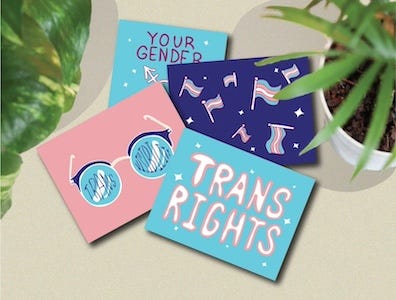 a set of four postcards in pink, white, and blue with text like Trans Rights and Trans Visibility