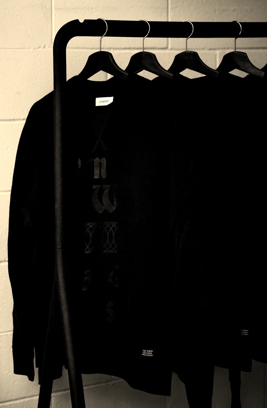 black sweatshirts on plastic hangers