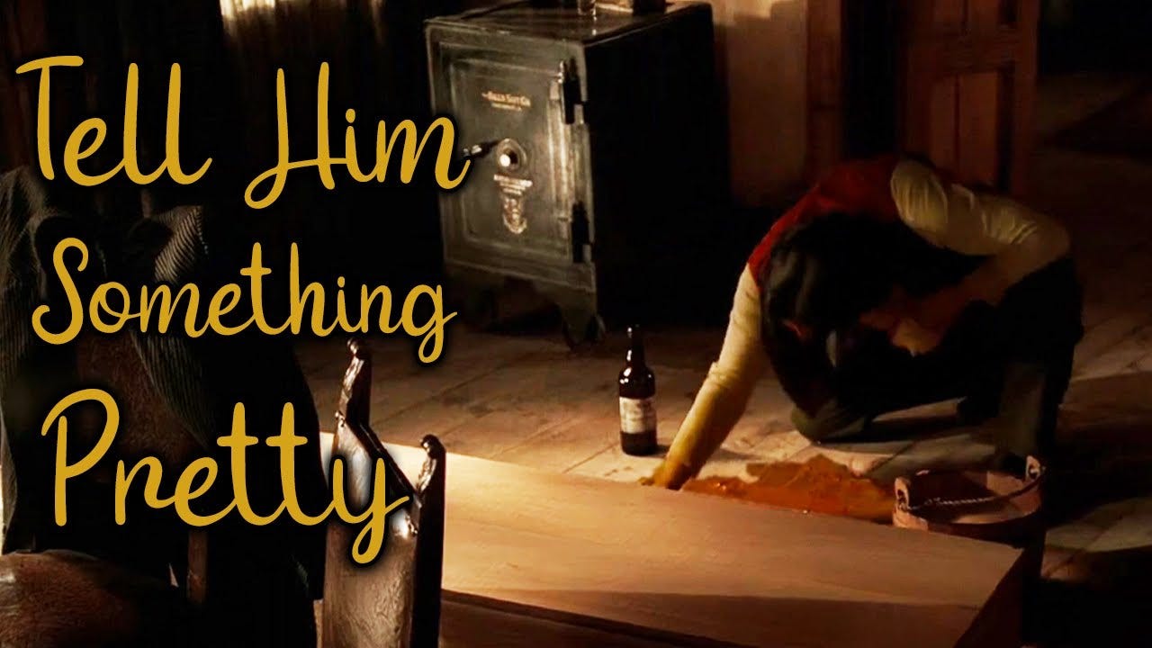 This image shows saloonkeeper Al Swearengen (played by Ian McShane) wiping blood from the floor of his office. A whiskey bottle sits on the floor next to Swearengen, while the episode's title, "Tell Him Something Pretty," appears in yellow cursive lettering that spans the shot's left third.