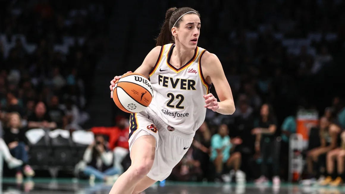 Caitlin Clark in her Indiana Fever uniform, hooping.