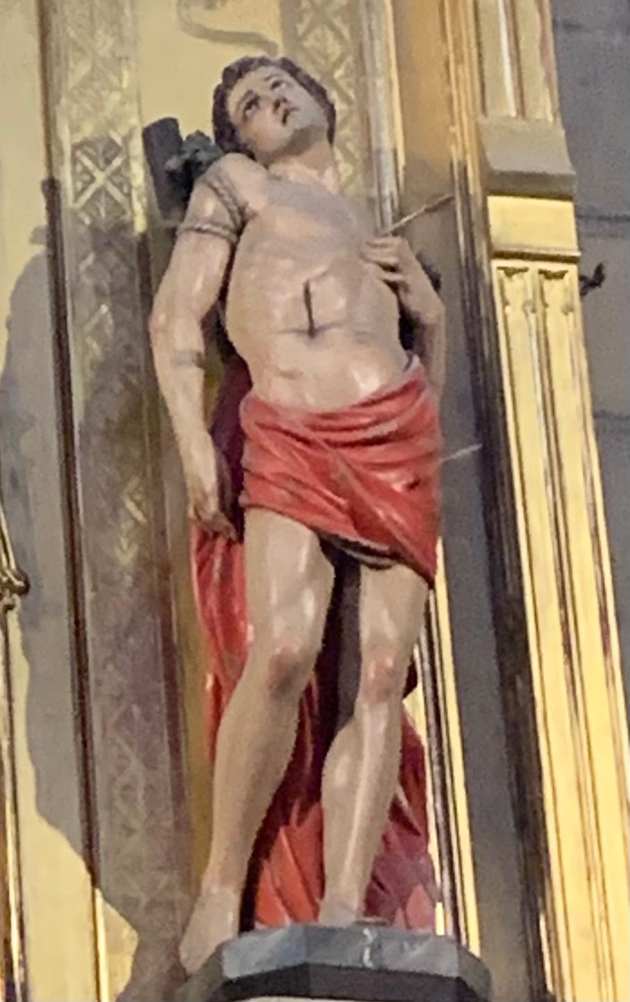 a statue of Saint Sebastian, looking quite bummed about the number of arrows he's been shot with.
