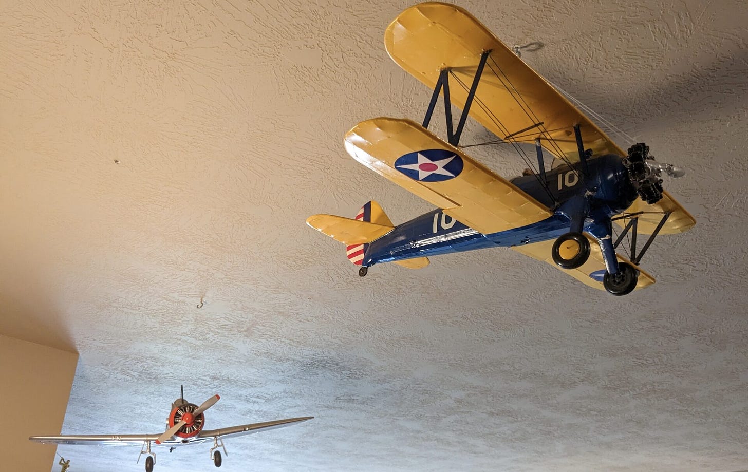Models of a Stearman biplane and an AT-6 Texan hang from the ceiling of Percy Grote's apartment. He learned how to fly both planes as a member of the U.S. Army Air Corps. Aberdeen Insider photo by Scott Waltman