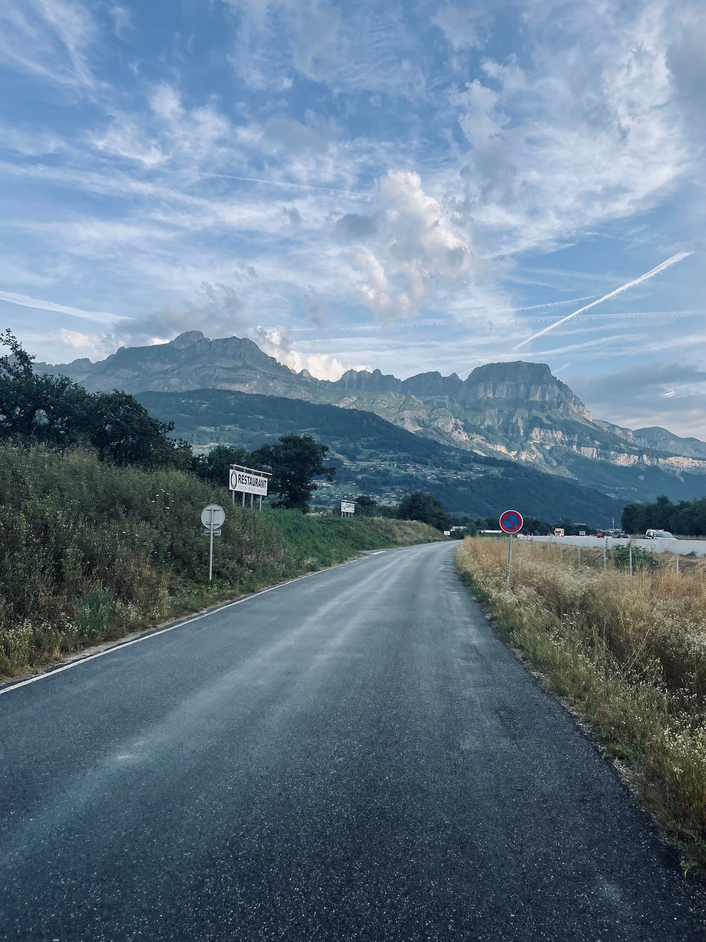 Asphalt road in the early morning with mountains in the background