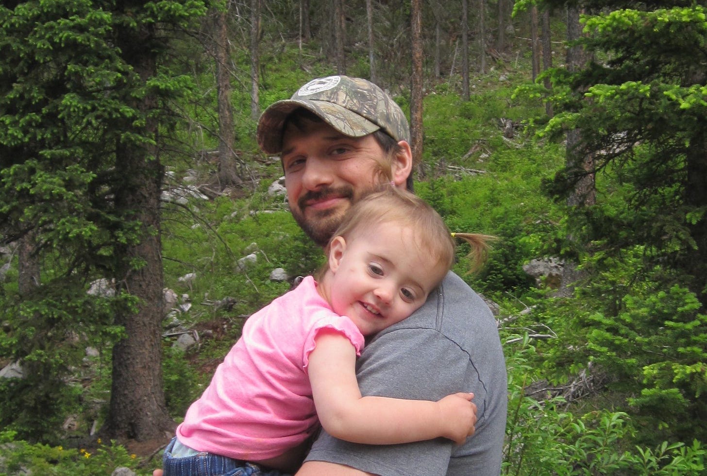 man with child in forest