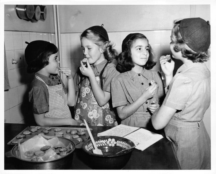 Image of Girl Scouts eating cookies