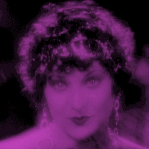 Animated gif - big close-up of Josephine de Beauharnais, in a deep purple tint, played by Gina Manes in 1927 film Napoleon. She looks out from behind a fan flirtatiously