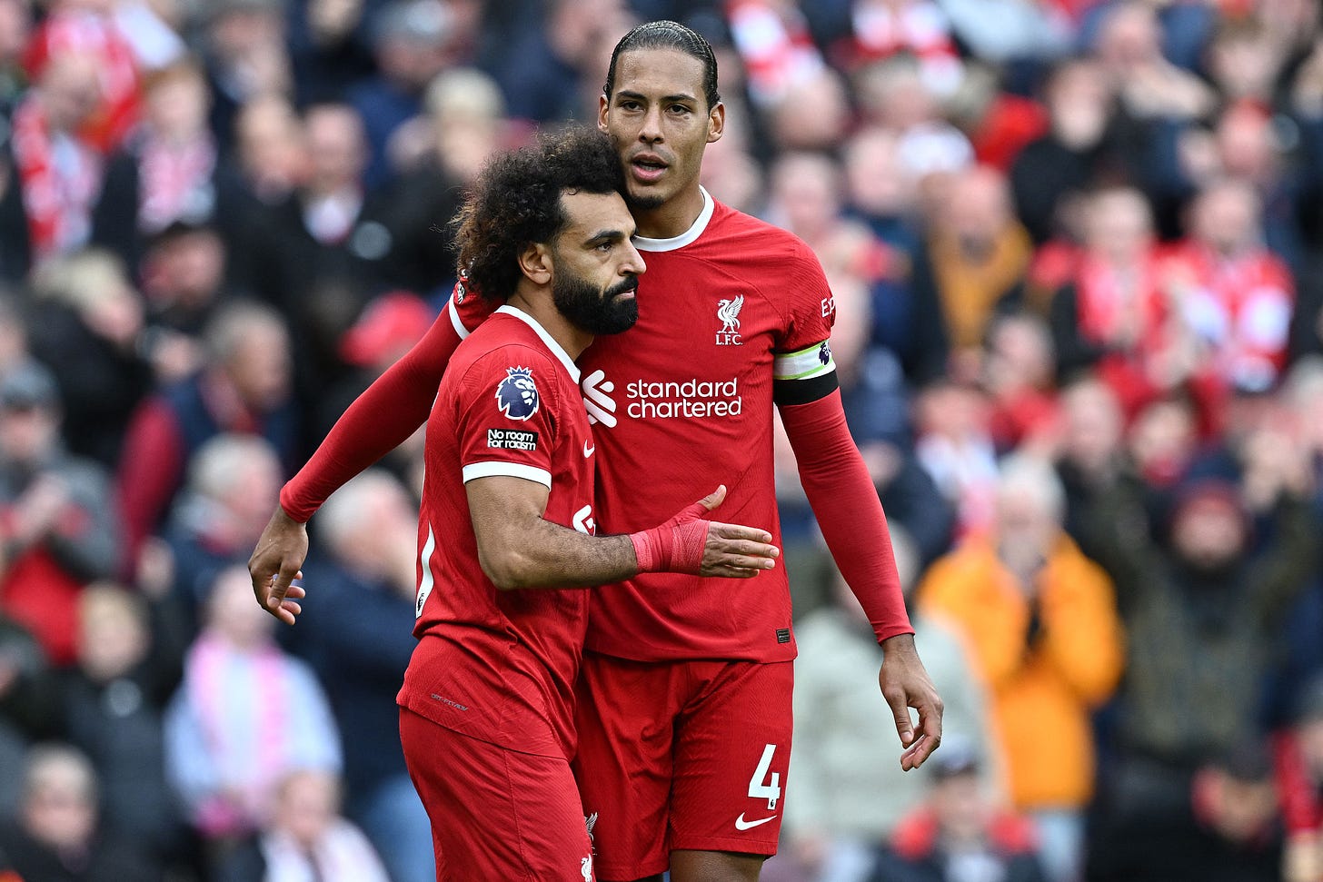Mohamed Salah is embraced by Virgil van Dijk as the red-shirted Liverpool duo celebrate their side's win over Everton