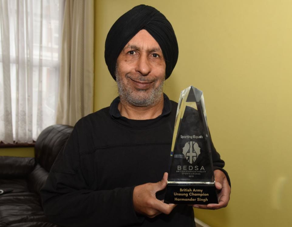 Redbridge legend, Harmander Singh holding his British Ethnic Diversity Sports Award for Unsung Champion