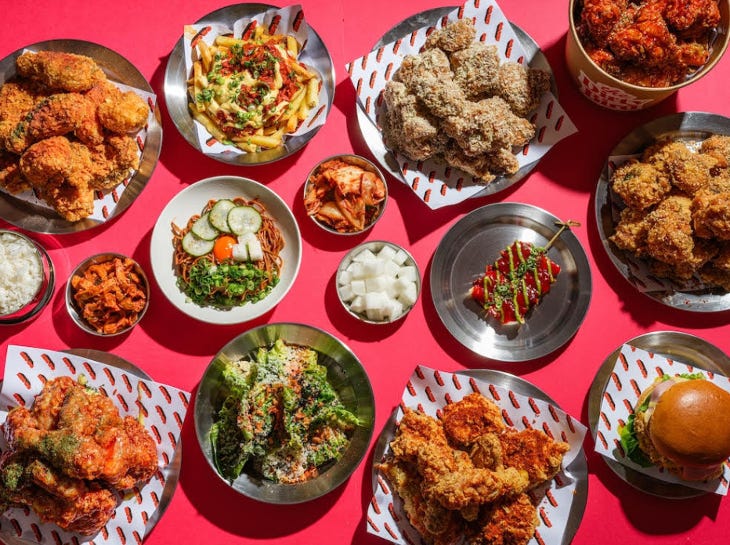 A selection of dishes, including kimchi, plated up on a table