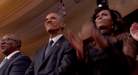 The Obamas, in some evening attire, dancing along with some other guests at an event