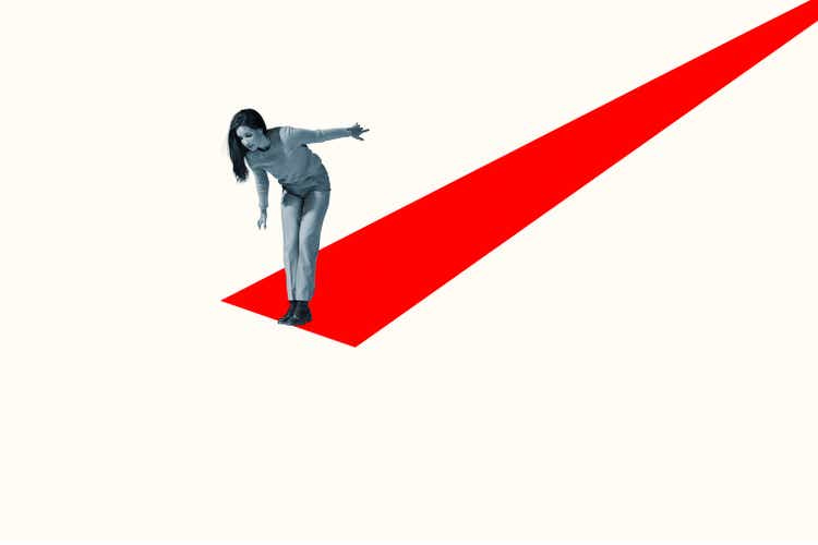Young woman at edge of red ramp looking down