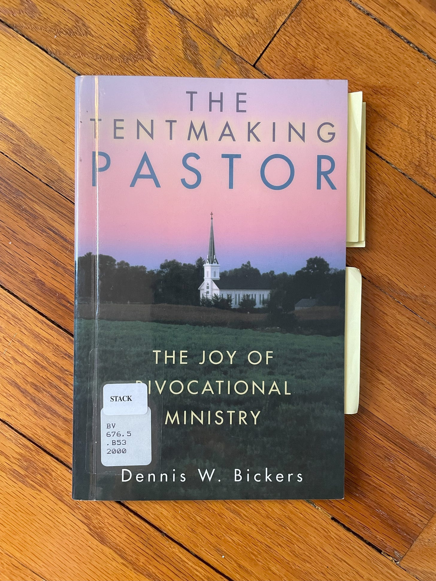 The book discussed, The Tentmaking Pastor, laying on a hardwood floor