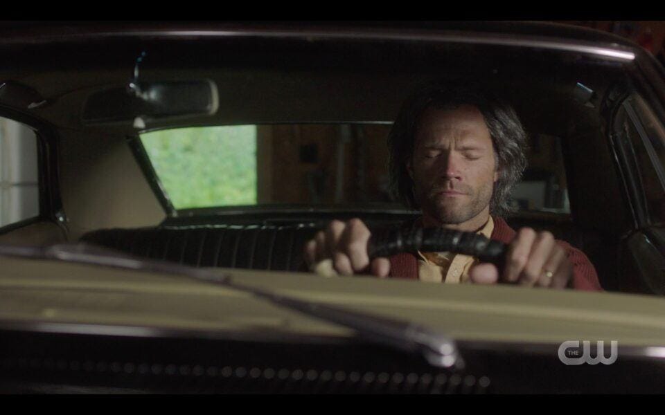 SPN Old Sam Winchester sitting in Impala in garage