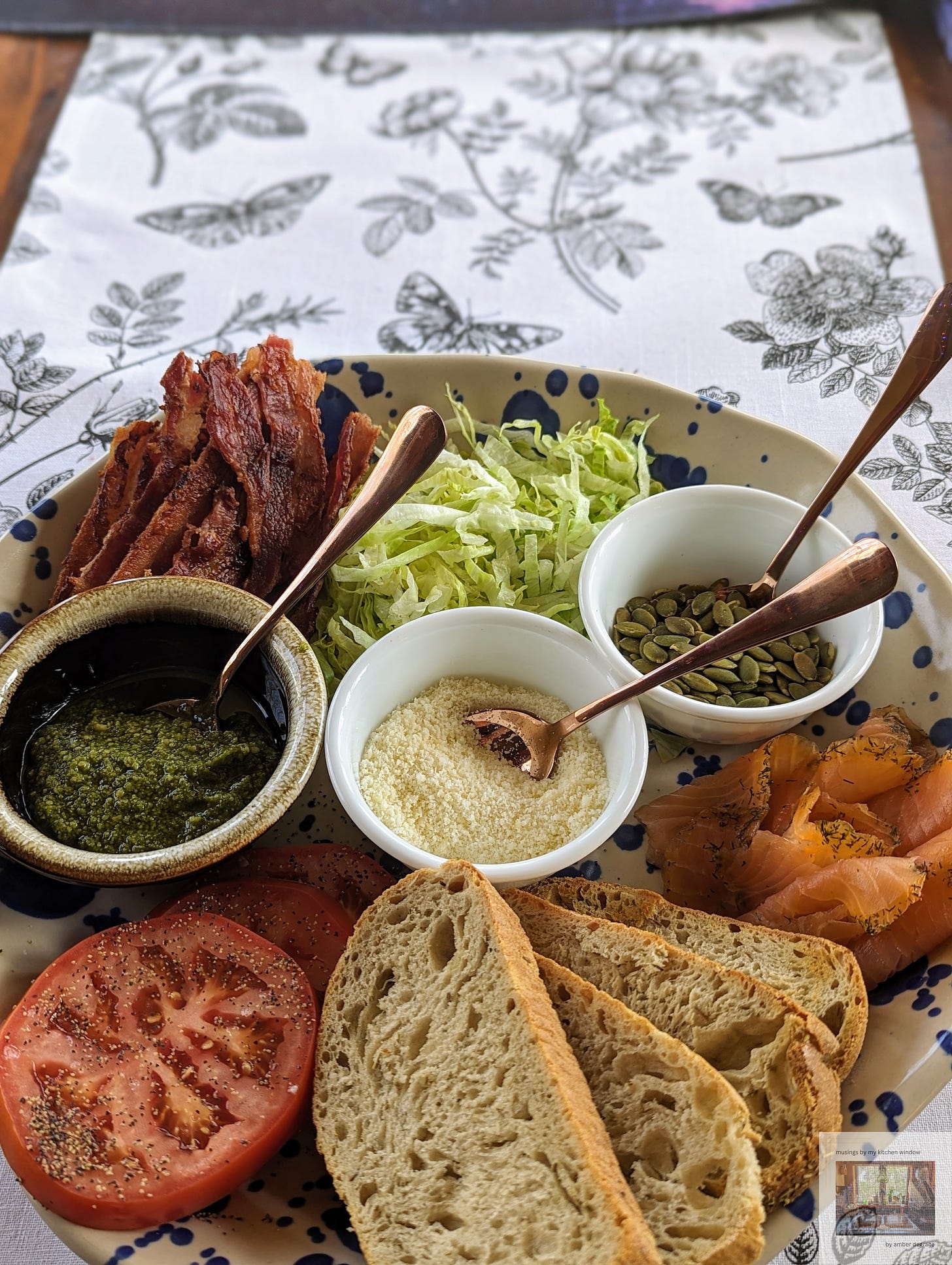 A non-traditional BLT board including smoked salmon, pesto, and pumpkin seeds.