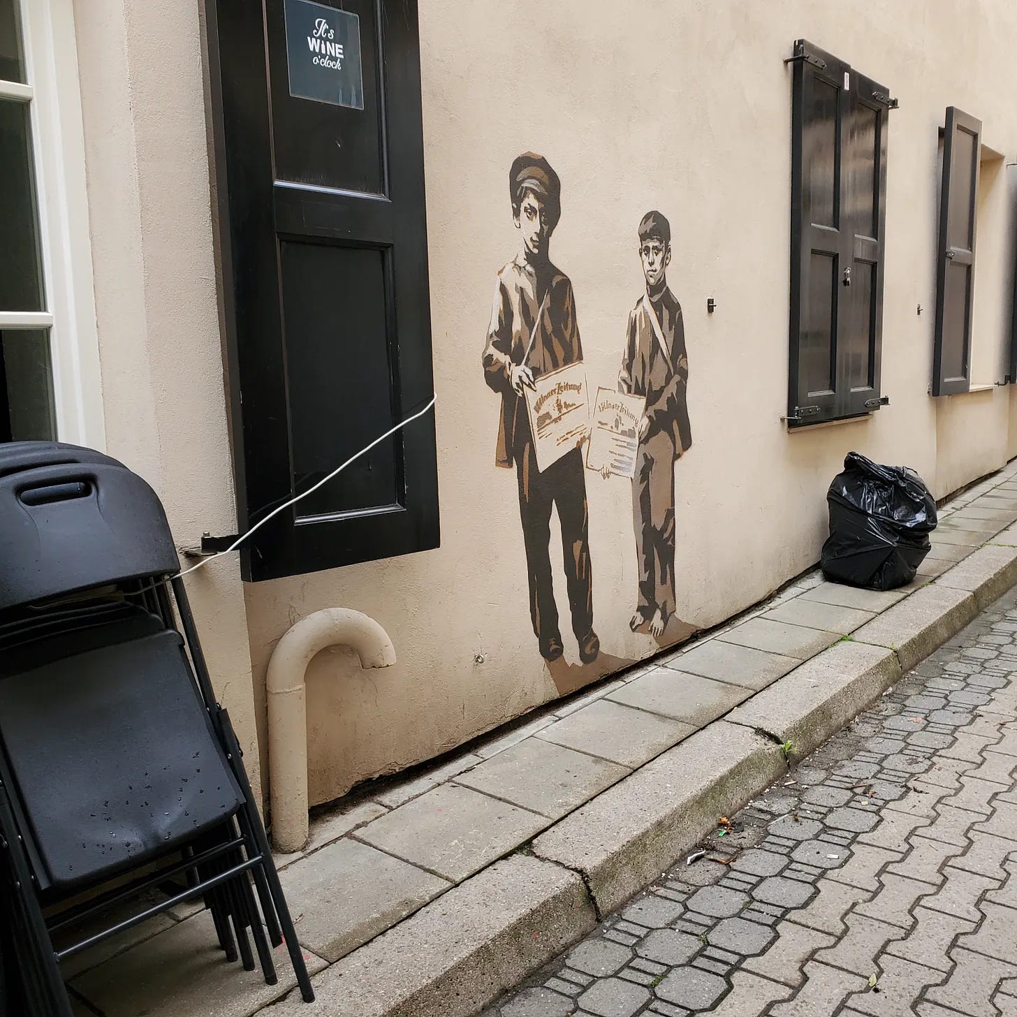 A mural of two small boys selling newspapers.