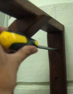 Screwing in brackets to wall