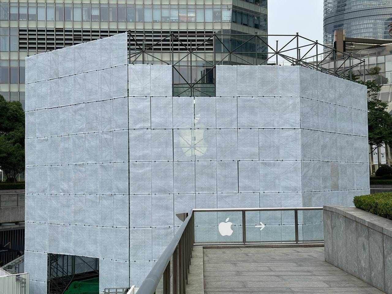 The glass entrance to Apple Pudong partially concealed by temporary scaffolding.