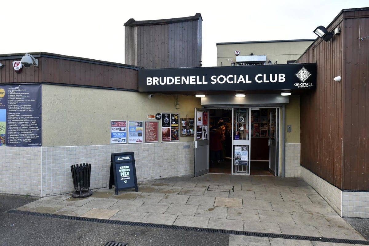 The outside of Brudenell Social Club with posters on the walls, a board advertising pies, and a black bin The outside of Brudenell Social Club with posters on the walls, a board advertising pies, and a black bin