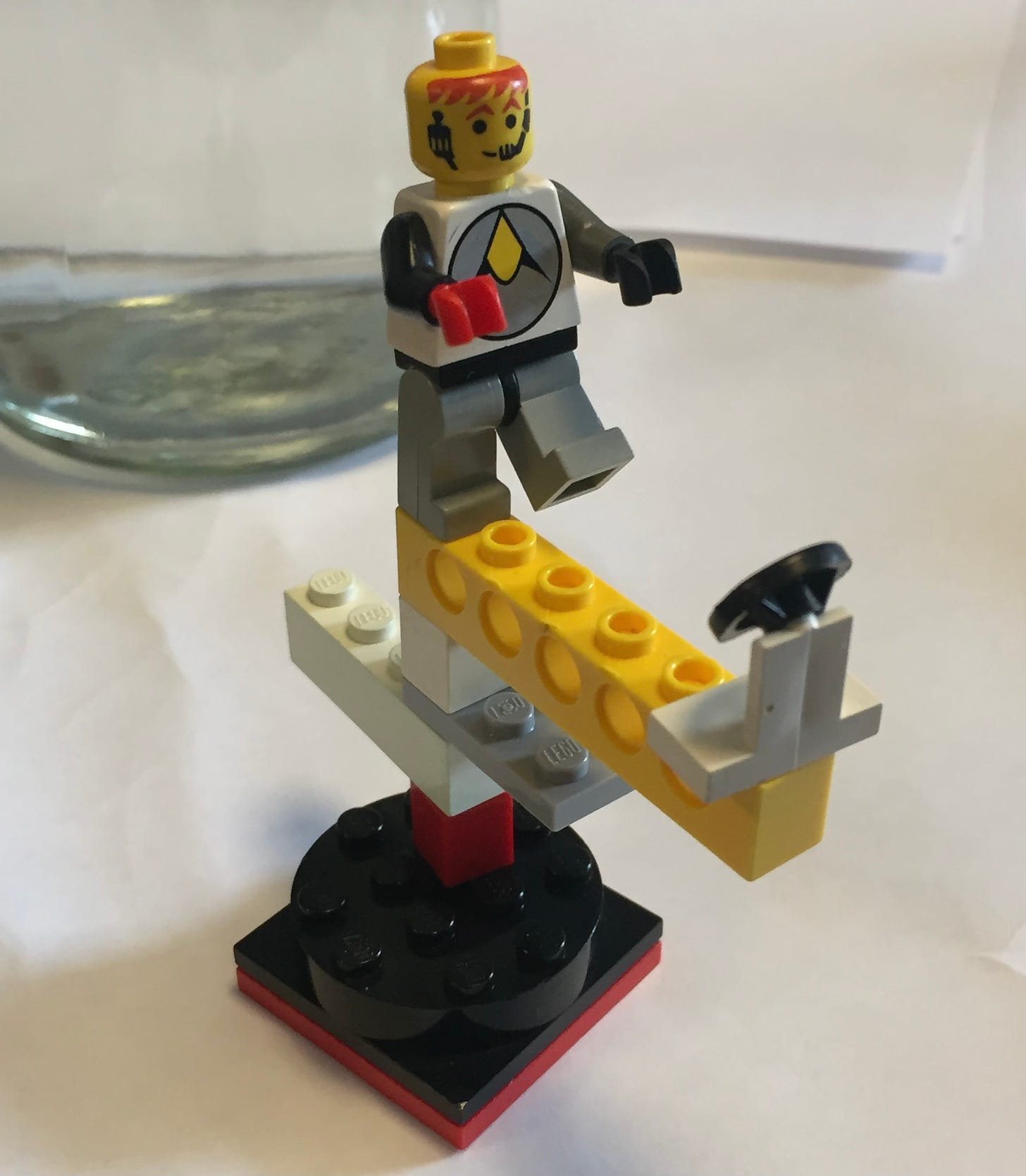 Lego person heading towards a steering wheel as if walking the plank: a playful depiction of leadership?
