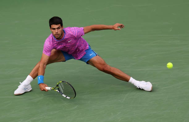 Carlos Alcaraz of Spain plays a forehand against Jannik Sinner of Italy in their Mens Semifinal match during the BNP Paribas Open at Indian Wells...