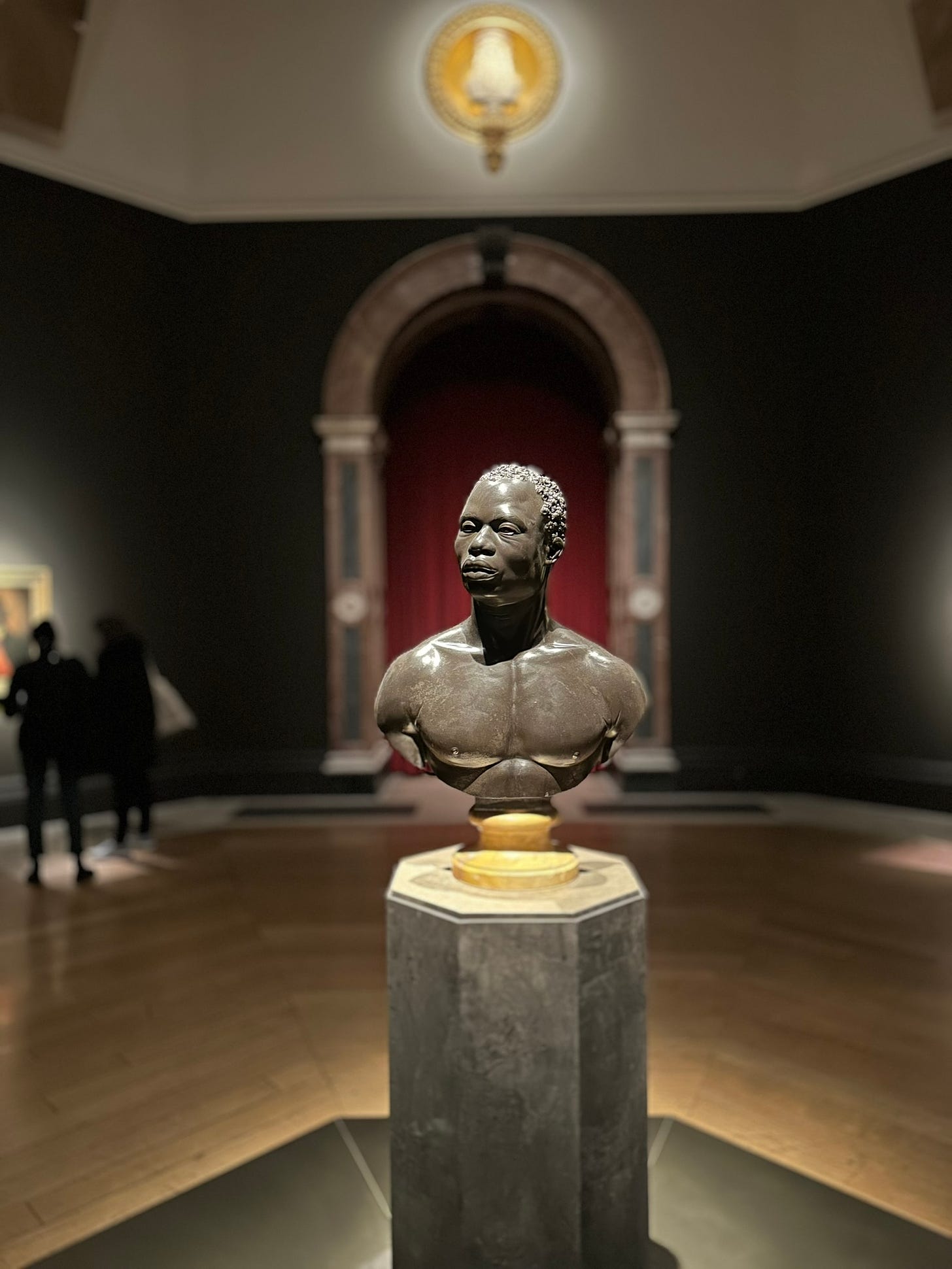 Eighteenth century bust of a Black man in a gallery.