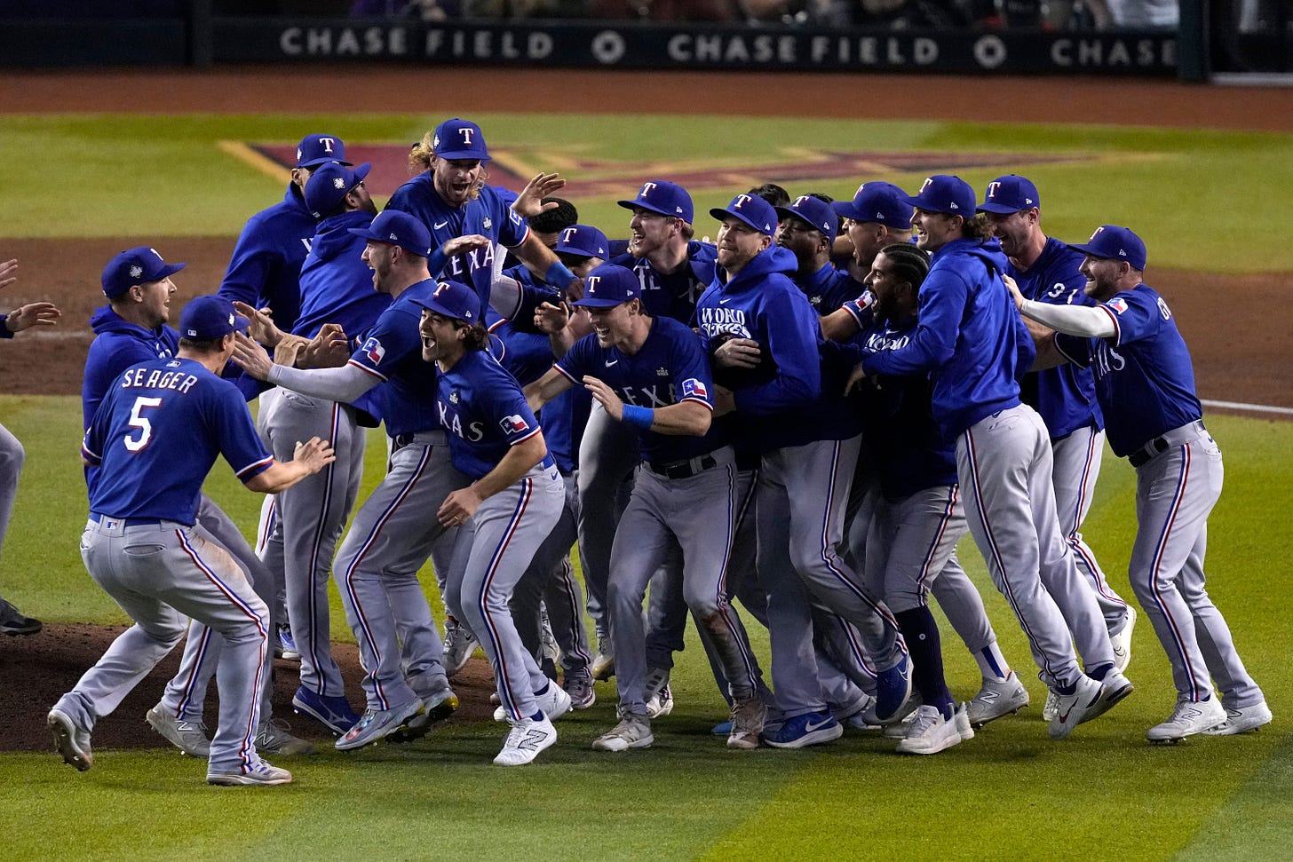 The Texas Rangers baseball team celebrates on the field after a victory