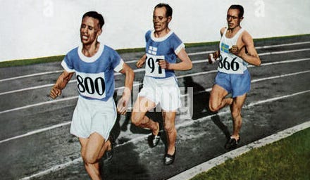 A group of men running on a road

Description automatically generated