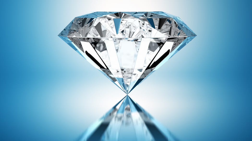 A large diamond perches in an azure space, its reflection below.