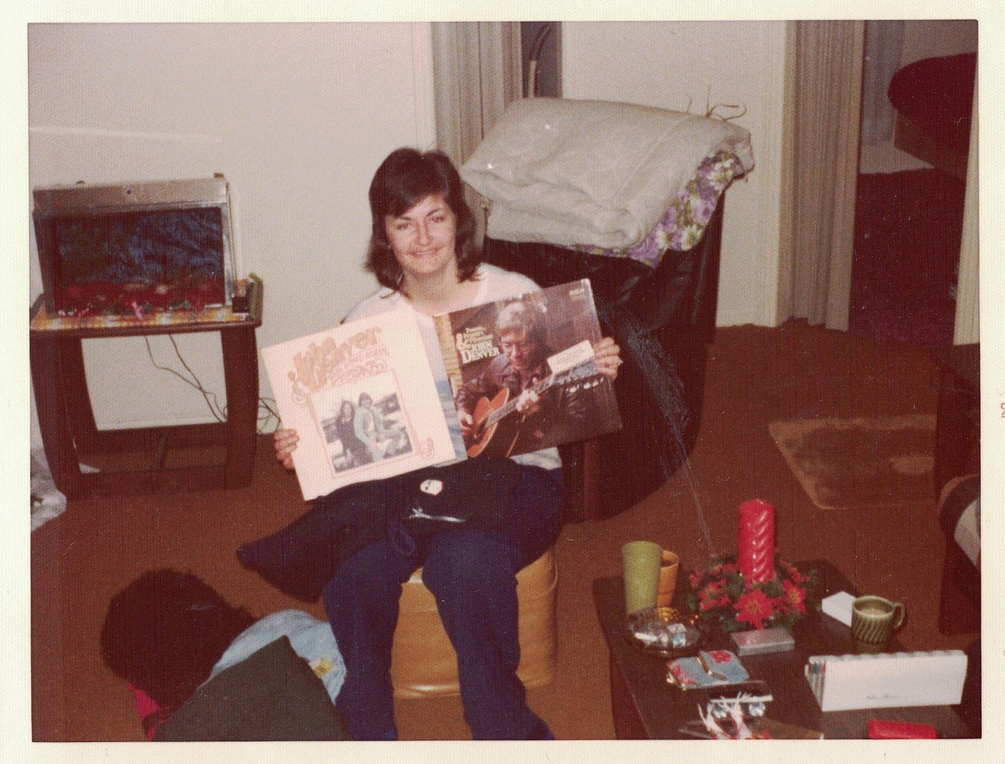My mother, receiving John Denver albums gifted to her by my father.