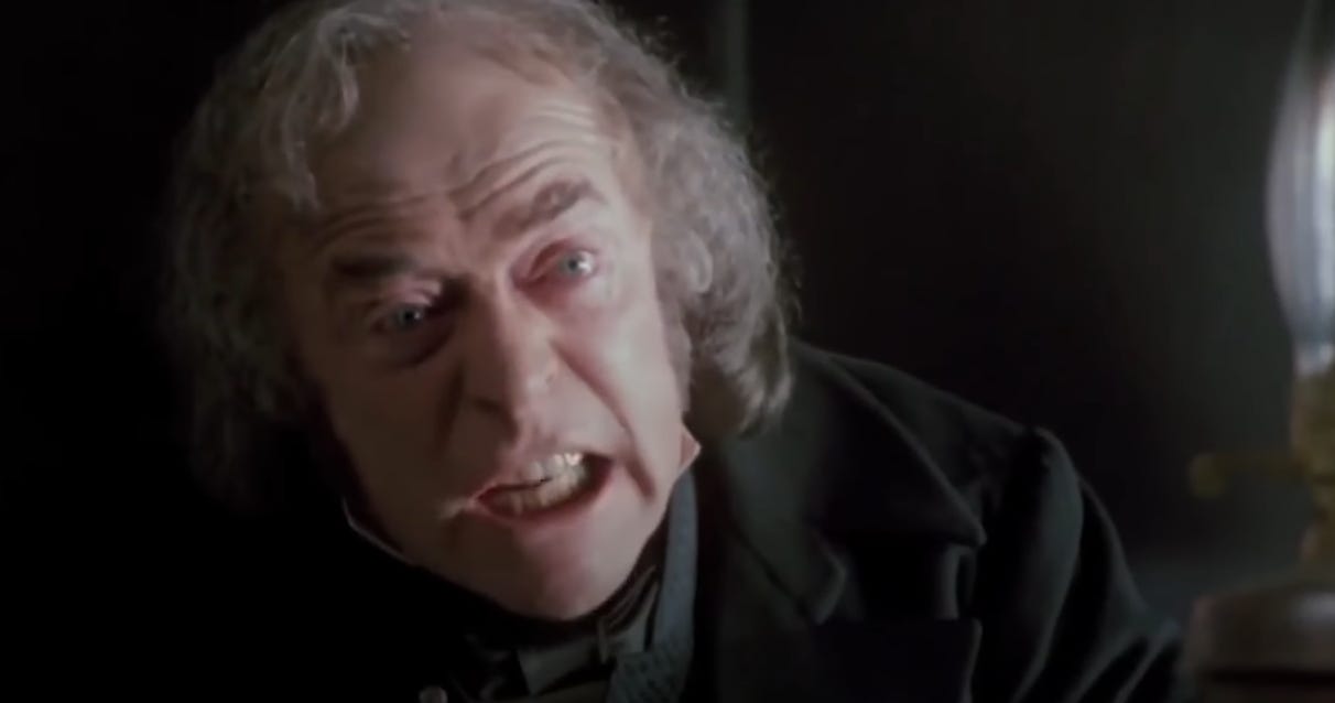 Michael Caine as Scrooge, shouting into the camera