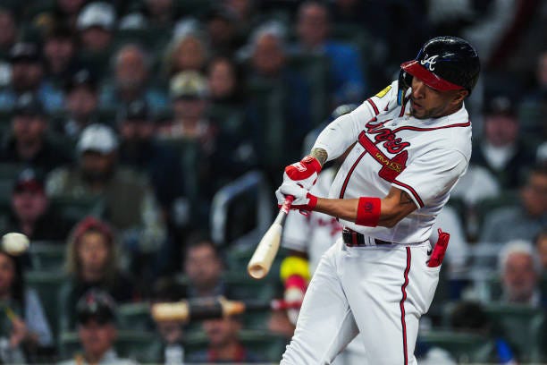 Eddie Rosario of the Atlanta Braves hits a single against the Philadelphia Phillies in the fifth inning during Game One of the National League...