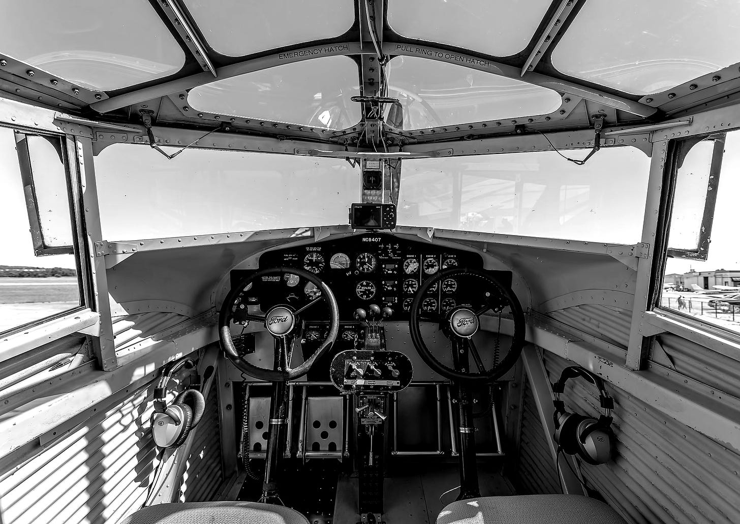 A black and white photograph of the interior of an airplane cockpit