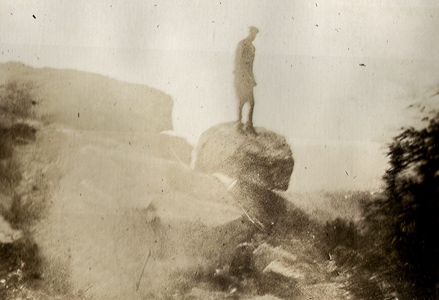 Man standing on balance rock