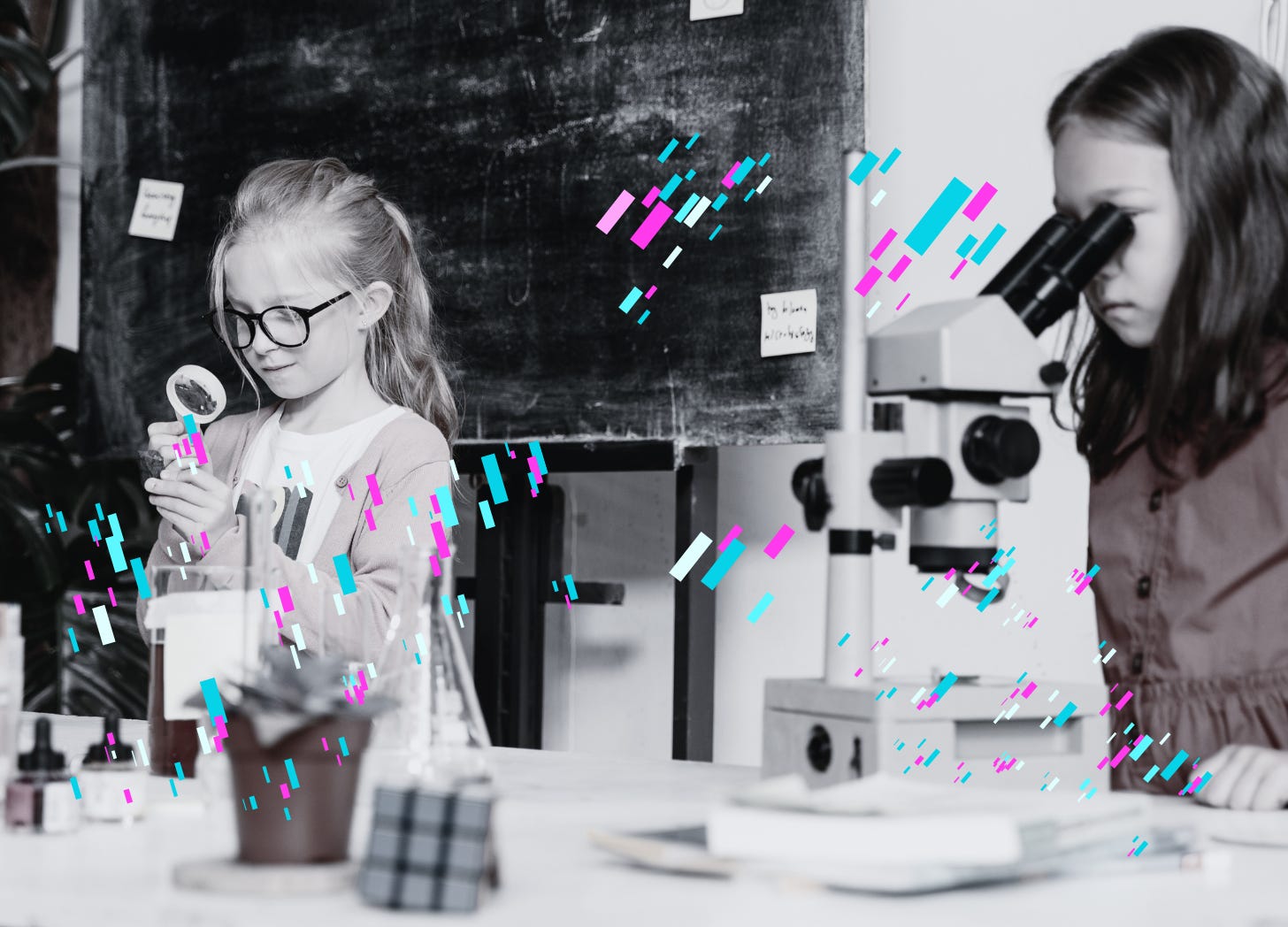 Two young girls in a classroom science lab working.