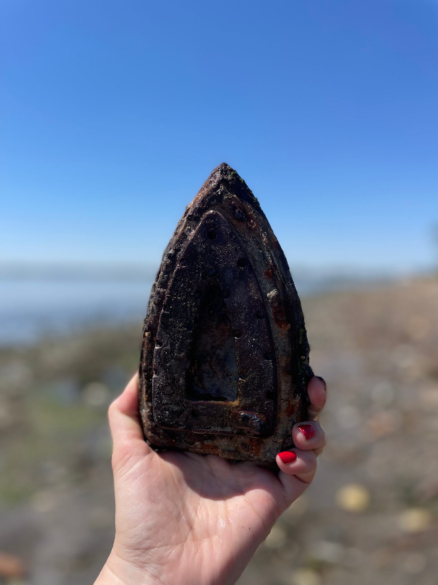 Vintage metal iron for clothes found at the beach