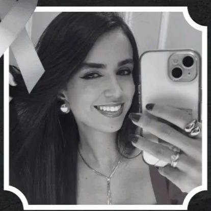 May be a black-and-white image of 1 person, smiling and jewelry