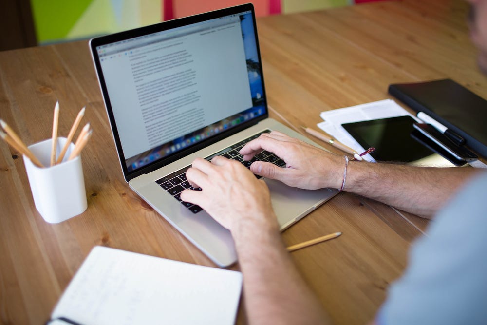 A person typing on a laptop