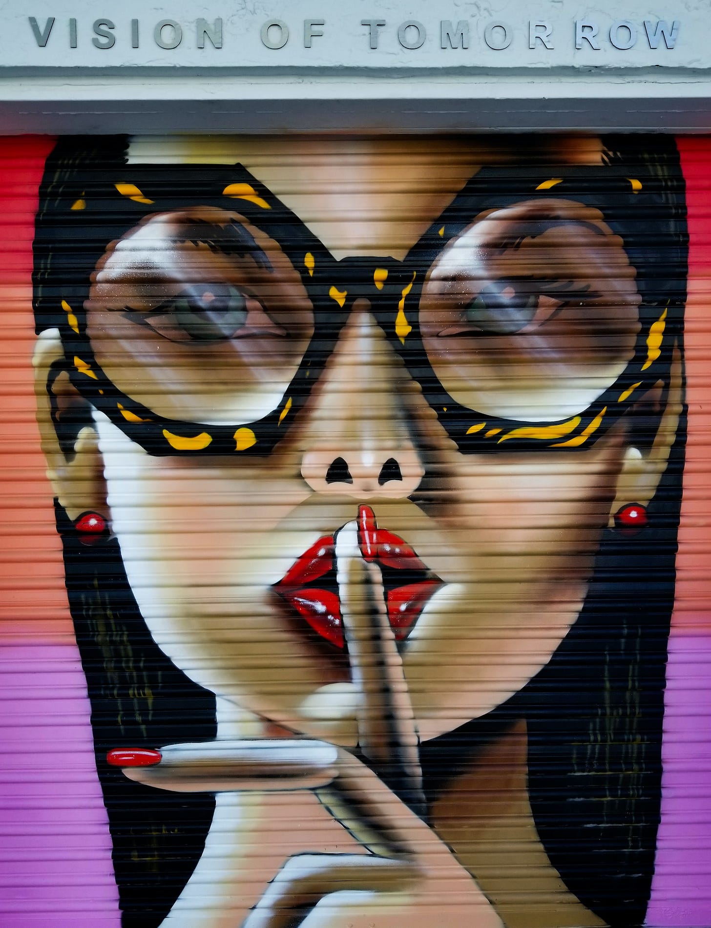A vision of Tomorrow Women doing the (Shhh...) finger to mouth graffiti 
Artist: Unknown