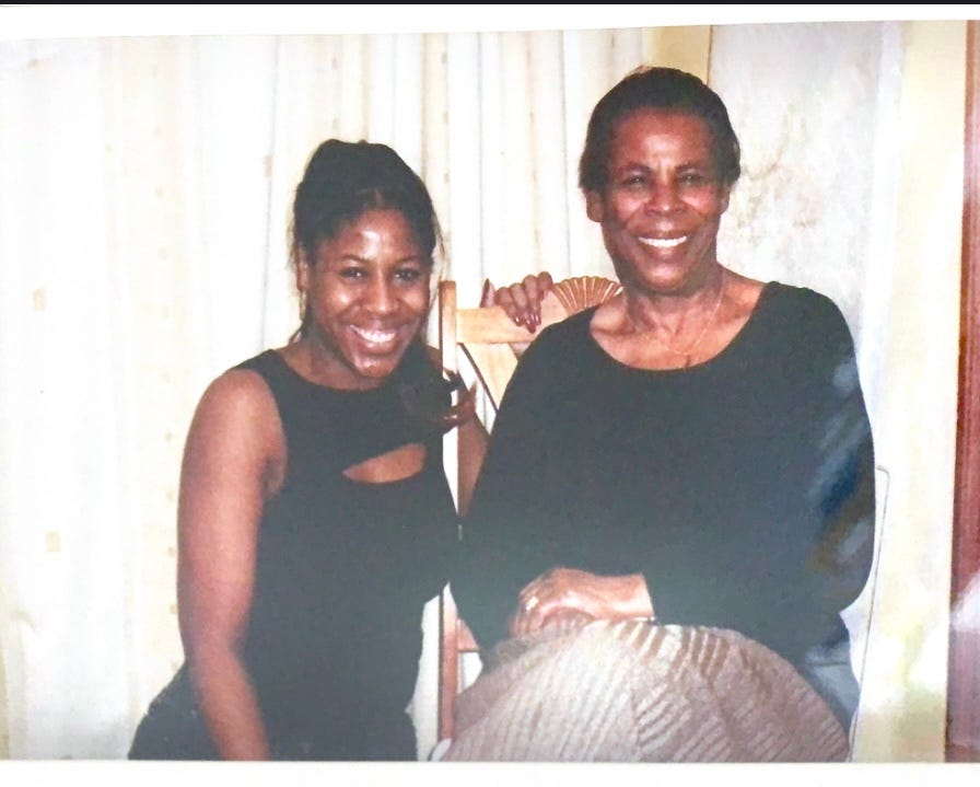 Black mother and daughter smiling