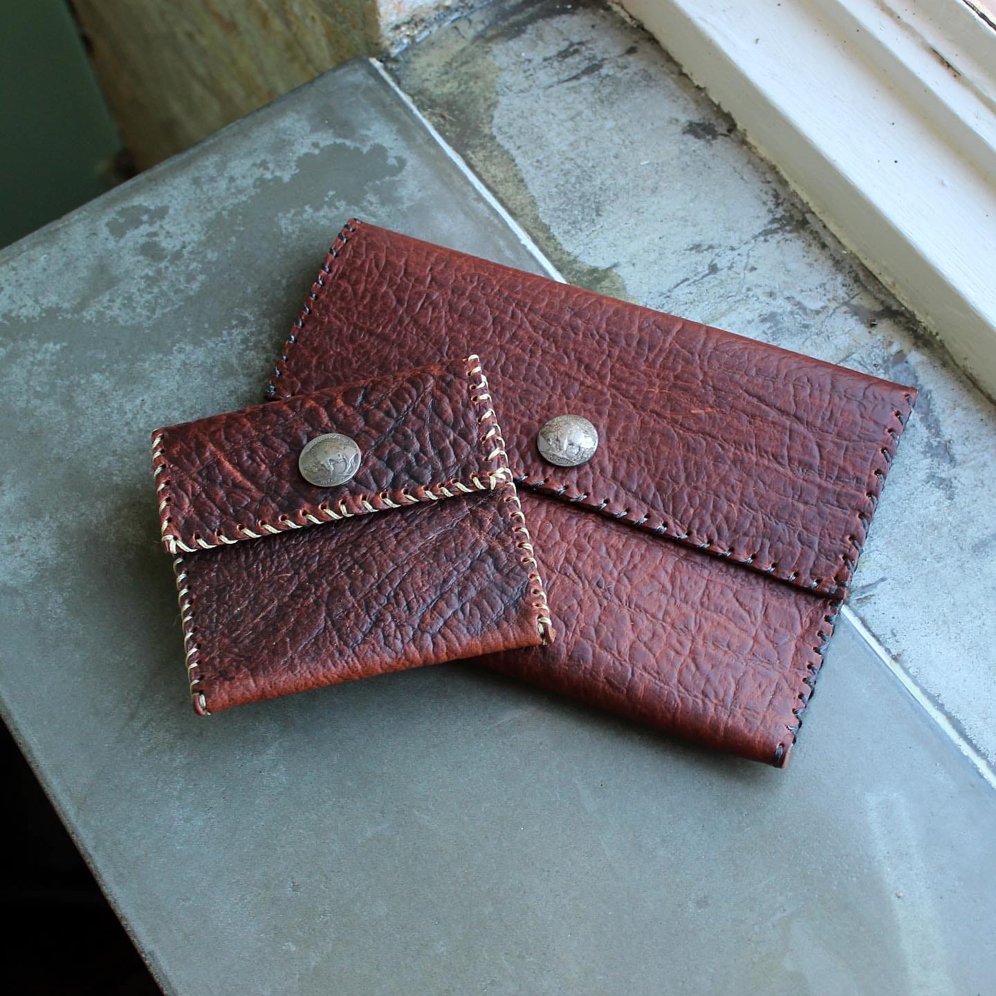May be an image of saddle-stitched leather, leather and leather wallet
