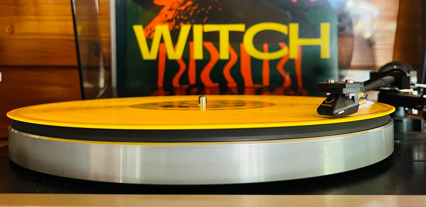 A bright yellow LP from the Zamrock band Witch sit's on a Thorens Record deck. The album cover is visible in the background.