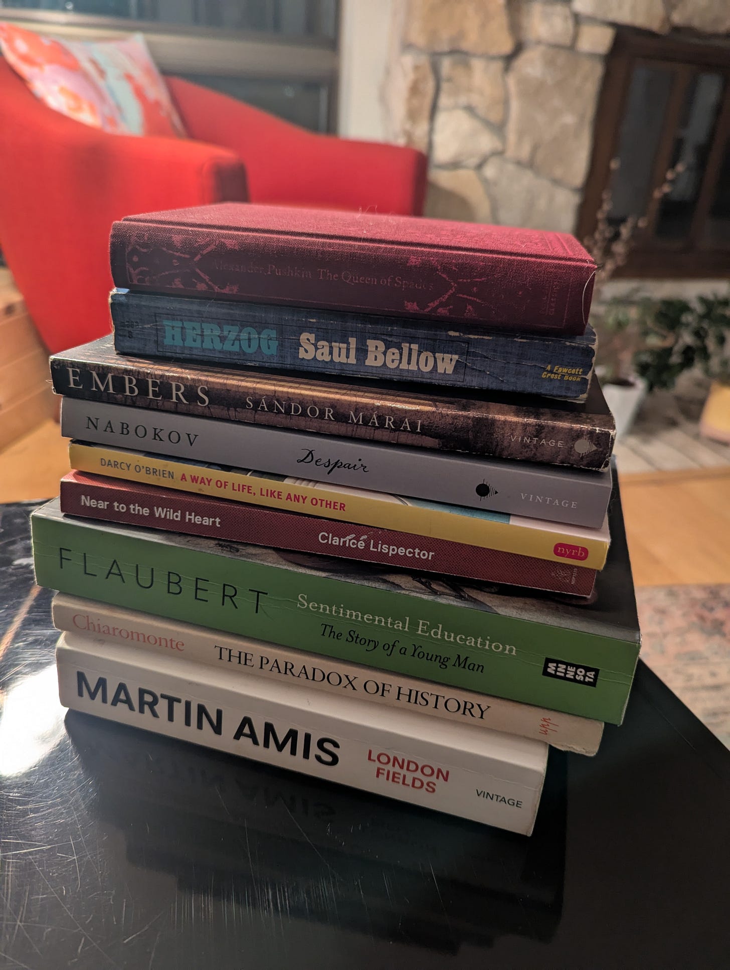 The books mentioned in this piece, stacked on a bench.