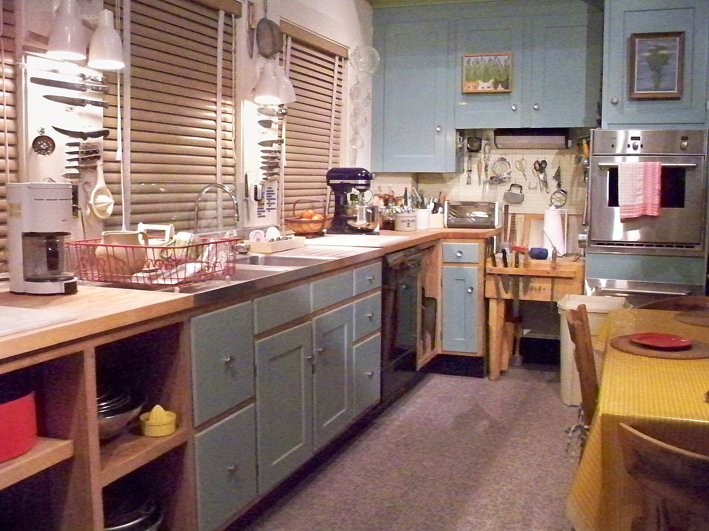 Julia Child's kitchen exhibit at the National Museum of American History. Blue cabinets, sink, mixer, kitchen tools.