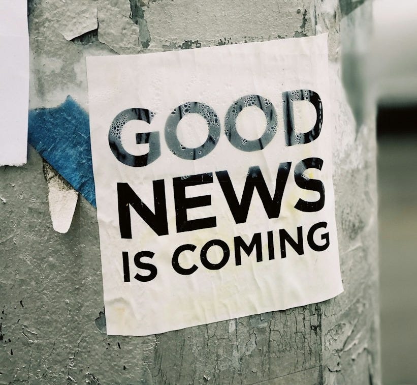 white Good News Is Coming paper on wall
