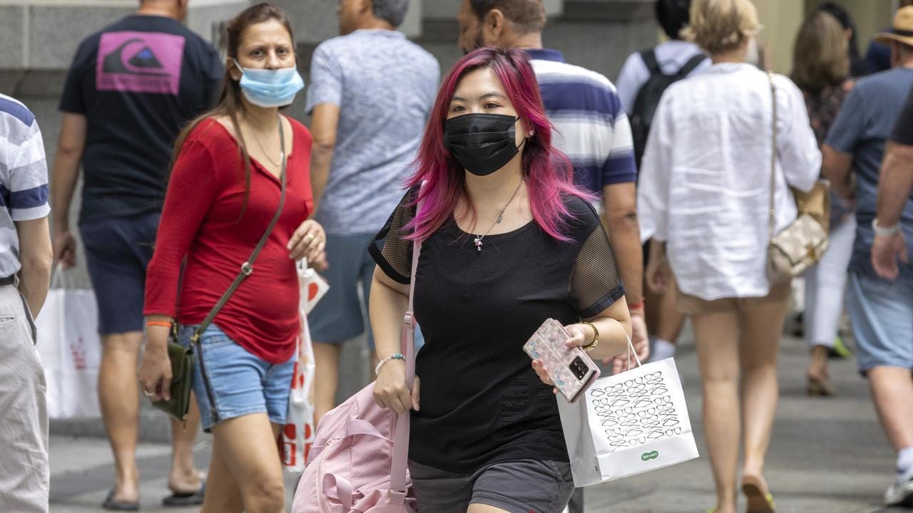 People wearing face masks in Queen Street Mall, Brisbane this month. Picture: Richard Walker