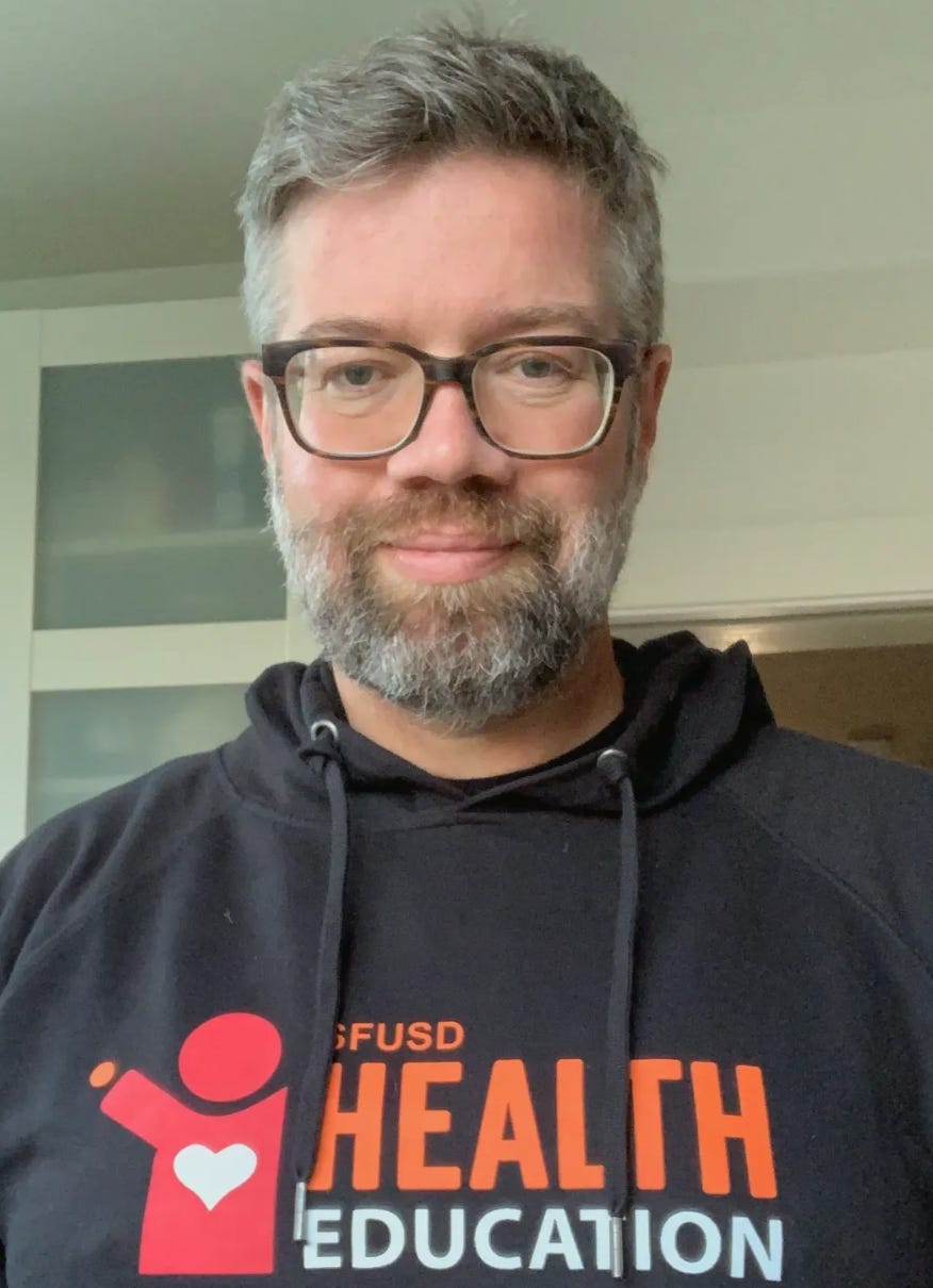 christopher pepper: a bearded white man with greying hair, in a SFUSD sweatshirt