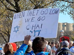 Sign at March for Israel, 11/14/13, "When they go low, we go Chai," with a Jewish star and the word Chai in Hebrew as well as English.