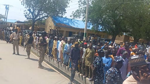 Voters, protected by soldiers, in Mafa during the Saturday election. Photo credit: Abdulkareem/HumAngle.