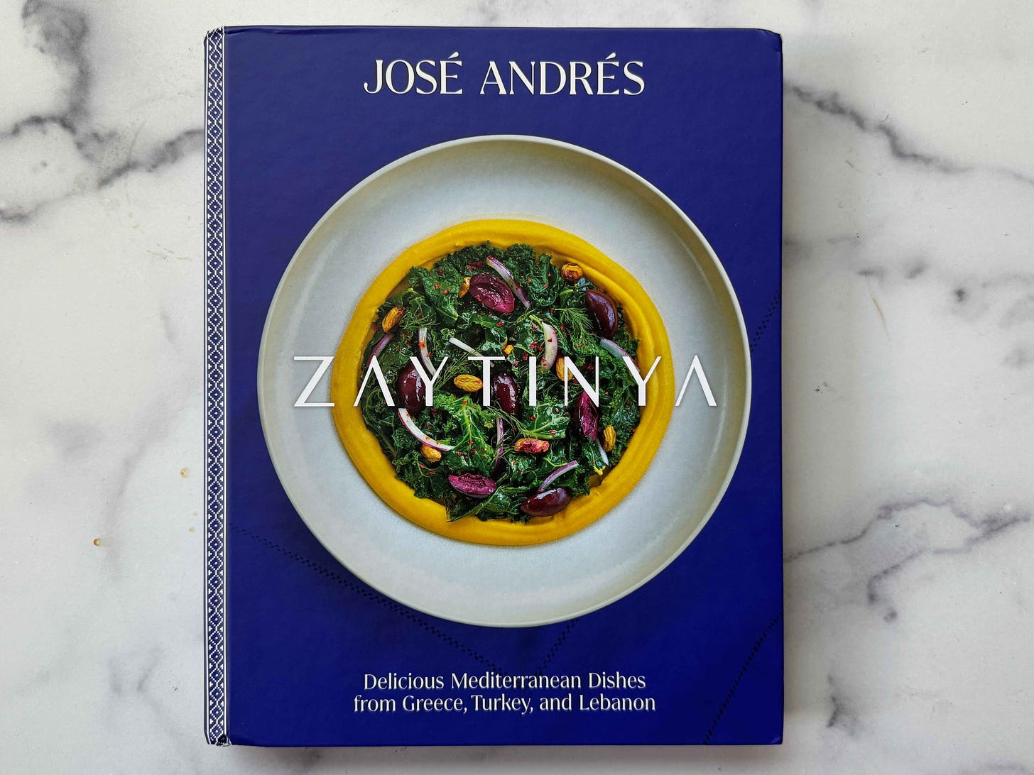 'Zaytinya,' a cookbook by José Andrés, on a marble board